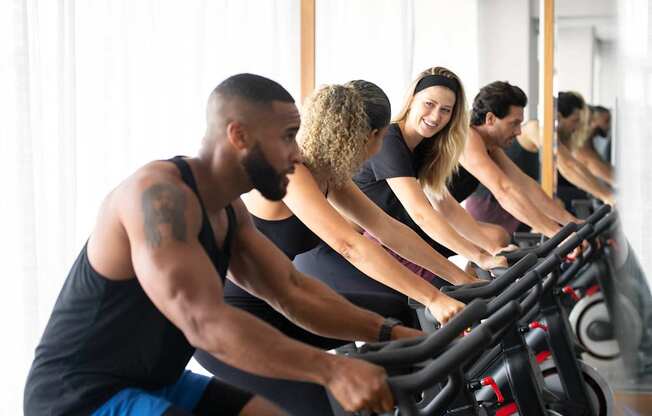 A group of people are working out on exercise bikes in a bright room. at Palma, Doral