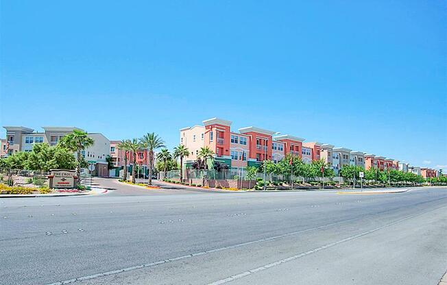 A street view of a residential area with apartment buildings on the right.