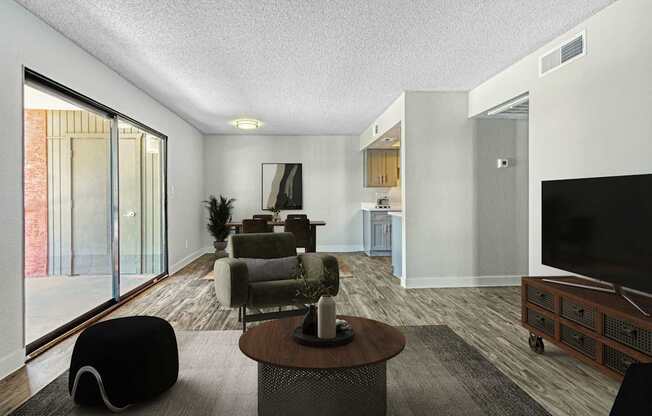 A modern living room with a black bean bag chair and a wooden coffee table.