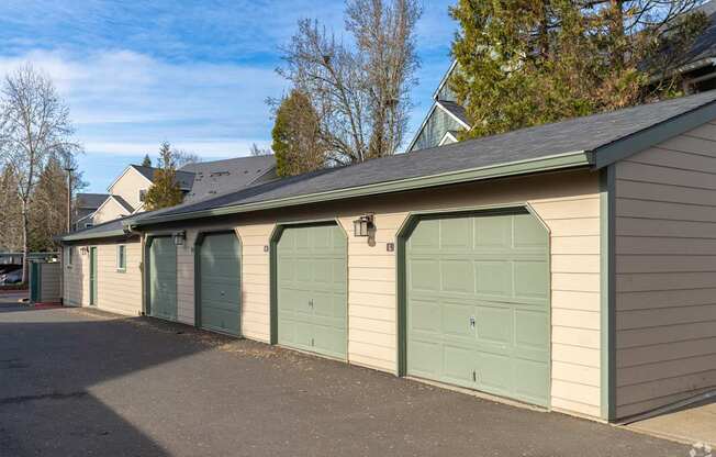 A row of garage doors in front of a house.