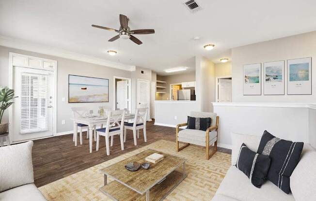 a living room filled with furniture and a ceiling fan