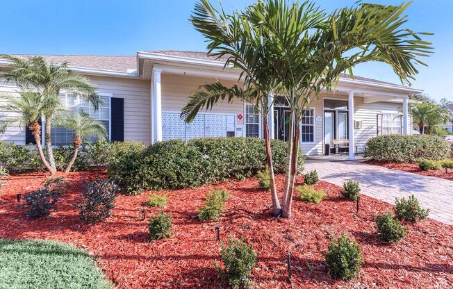 a house with bushes in front of a building