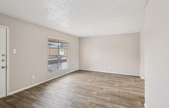 B6 living room with wooden flooring and a window at Windridge on the Parkway in Dallas, TX