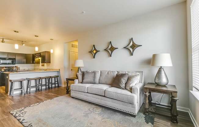 a living room with a couch and a kitchen in the background