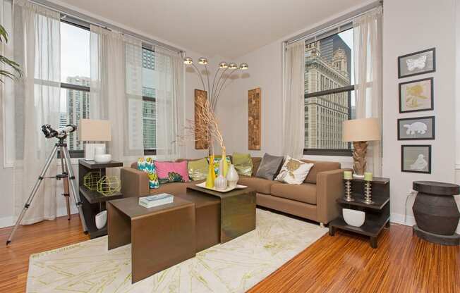 a living room with a brown couch and a large window