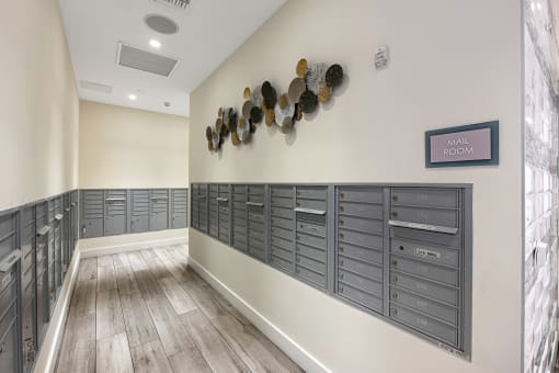 a lockers room in a building with wood floors and a wall with several shelves