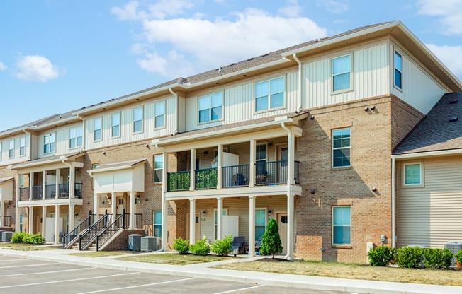 a brick apartment building with balconies and stairs