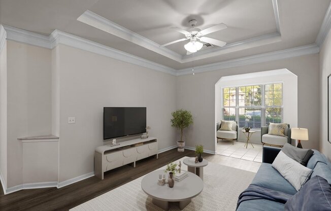 A living room with a television, a sofa, and a coffee table.