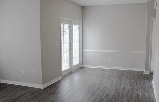 Enclave at Wolfchase Apartments in Cordova Tennessee photo of an empty living room with a door and a window