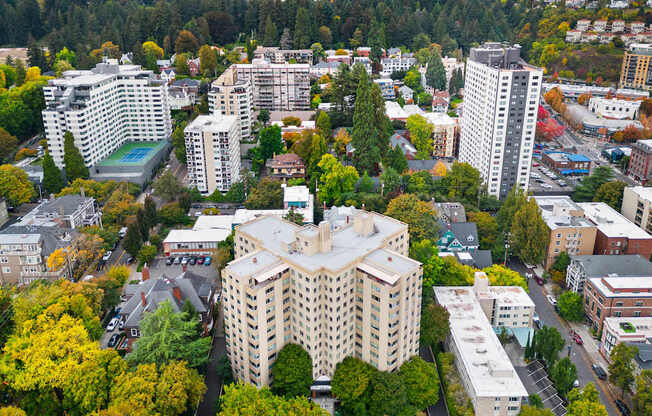 an aerial view of a city with buildings and trees