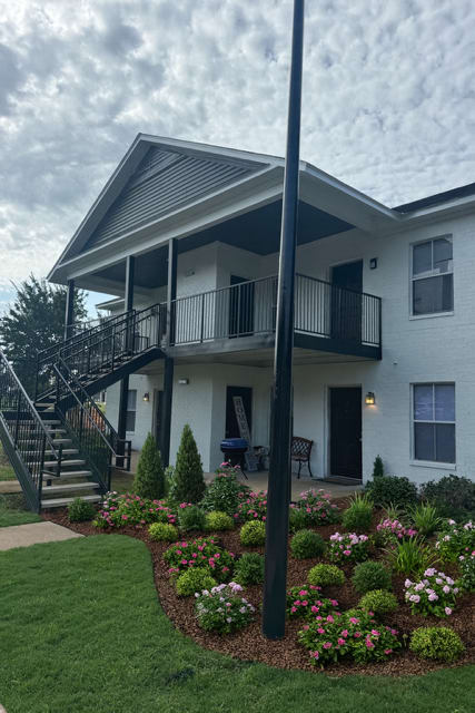 A house with a balcony and a staircase leading to it.