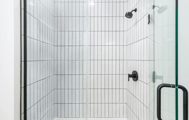 Crisp lines and sleek finishes define the contemporary showers at Modera Higley Commons.