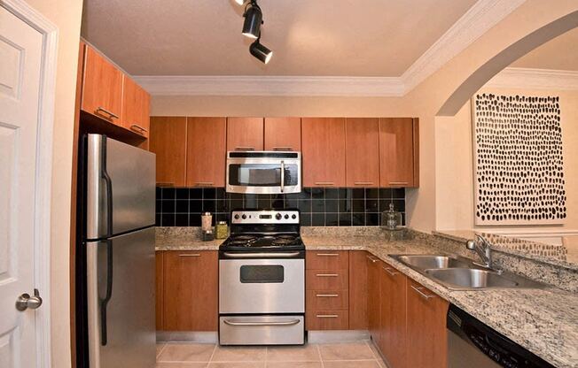 a kitchen with a stove refrigerator and a sink