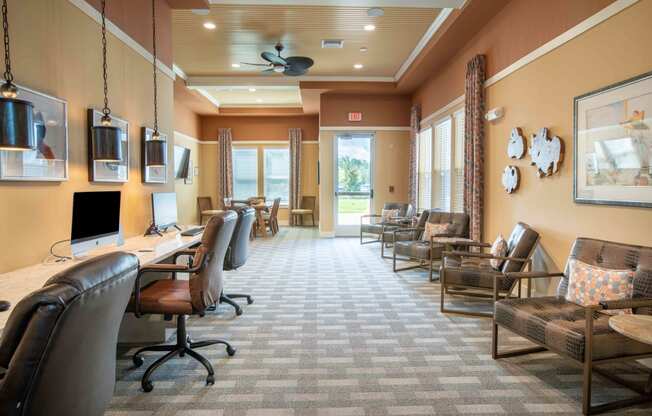 a conference room with chairs and a desk and a computer