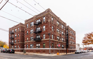 a red brick apartment building on a city street