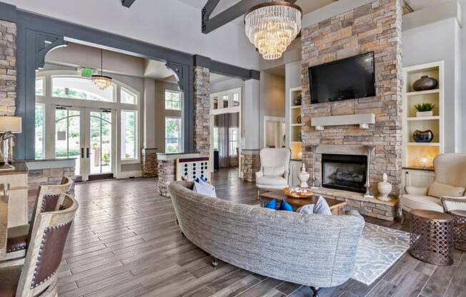 a living room with a large stone fireplace and a couch