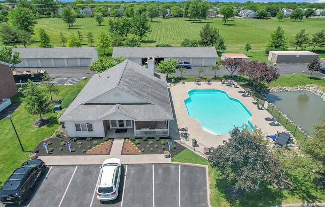 a home with a swimming pool in front of it