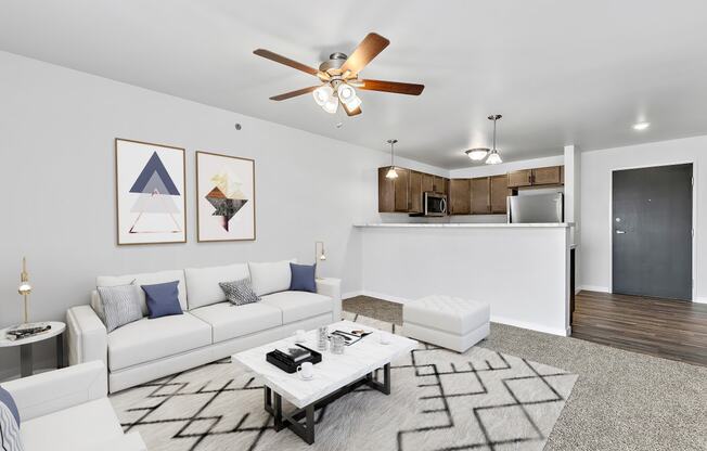 a living room with white couches and a coffee table