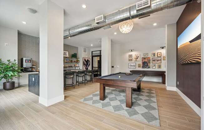 a community room with a pool table and a bar at The Quarry Luxury Apartment Homes, Colorado, 80526