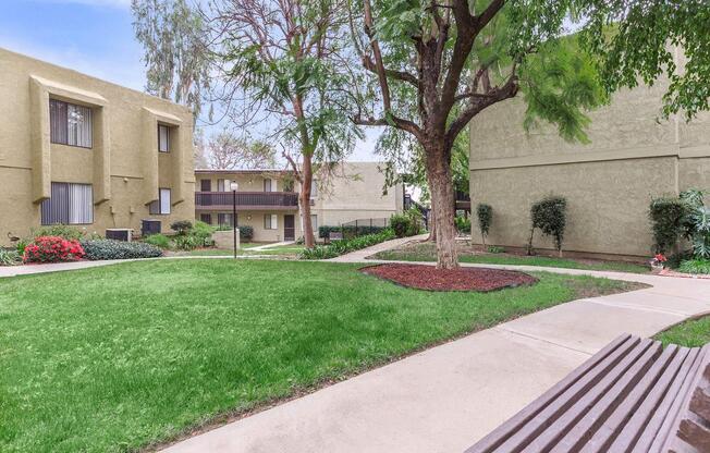 an empty park bench sitting in front of a building