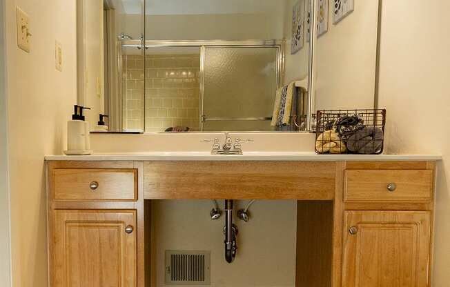 A bathroom with a sink, mirror, and toilet.