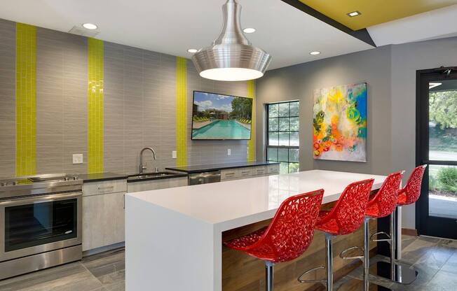 Community Room with seating, a full kitchen, and lounge chairs at Eden Commons in Eden Prairie, MN 55344