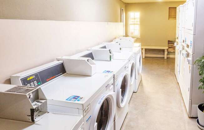 A row of washing machines in a laundromat.