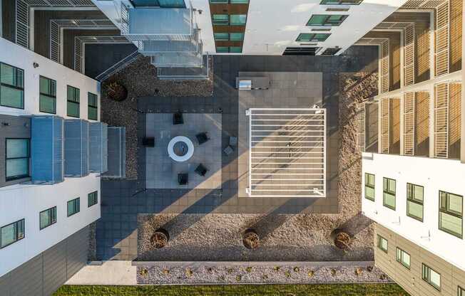 an aerial view of a building with stairs and a courtyard with a pool