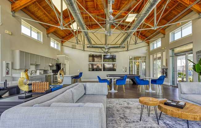 A modern open plan living and kitchen area with a grey sofa.