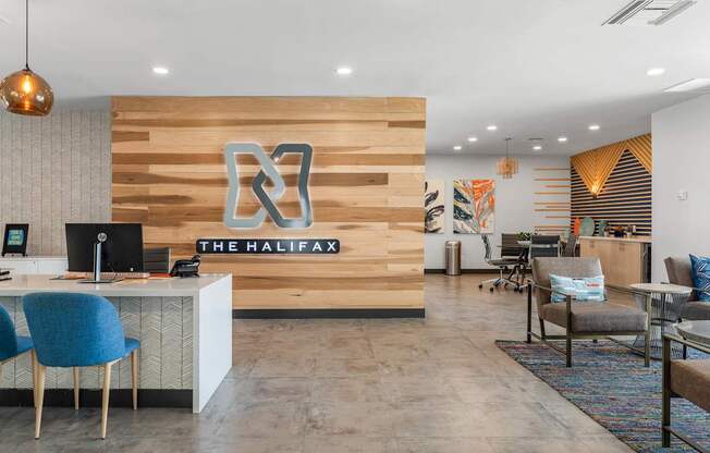 A reception area with a wooden wall and a sign that says "The Halifax".