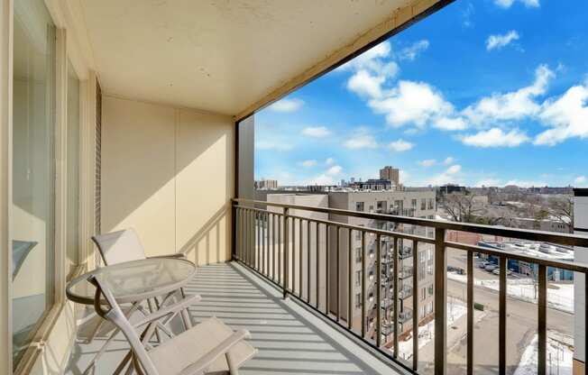 the view from the balcony of a condo with a glass table and chairs