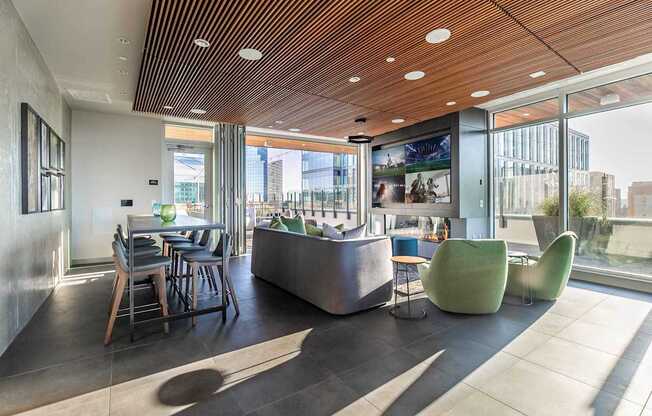 A modern interior space with a wooden ceiling and a large window overlooking a cityscape.
