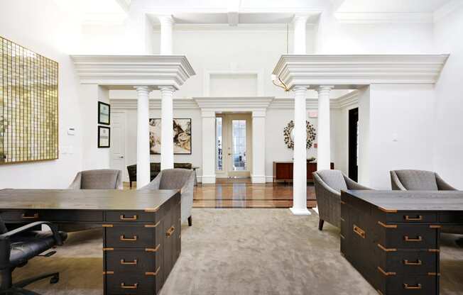 a conference room with two desks and chairs and a rug