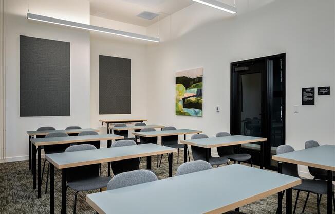 a classroom with tables and chairs and a door
