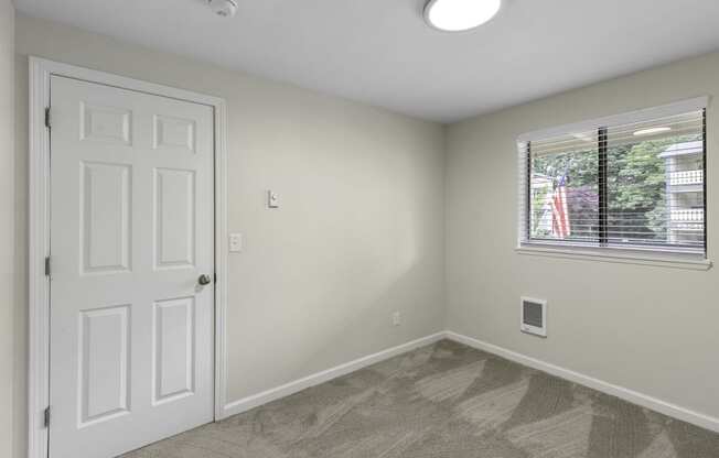 Living Room with a white door and a window at Swiss Gables Apartment Homes, Kent, Washington 98032