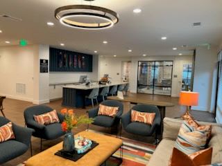 A living room with a couch, chairs, and a coffee table.