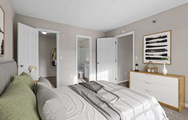 A bedroom with a bed, dresser, and mirror.