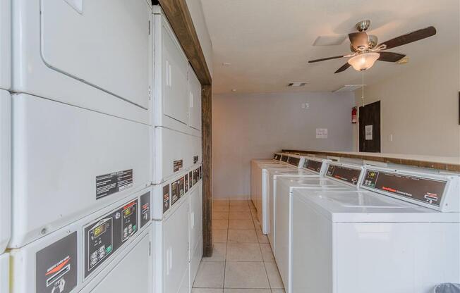 a laundry room filled with washers and dryers