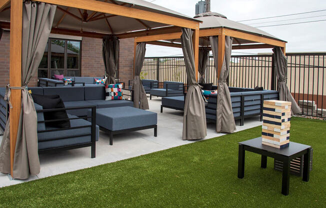 UPII outdoor lounge seating with oversized outdoor jenga and cabanas at Urban Park I and II Apartments, St Louis Park