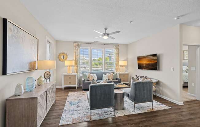 a living room with furniture and a ceiling fan