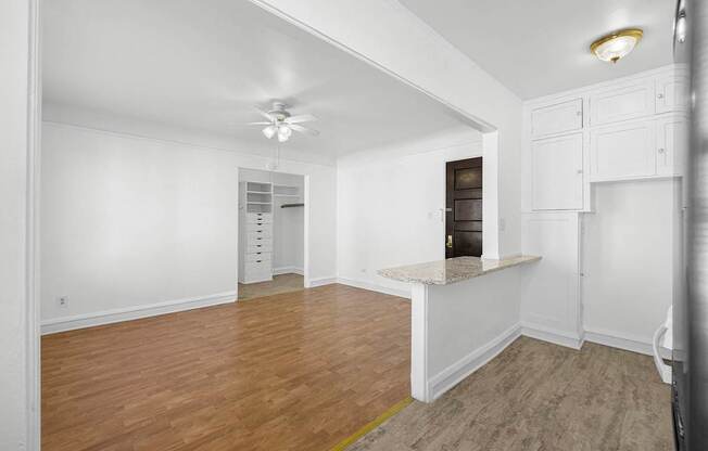 A room with wooden floors and white walls at Pleasant Oak Apartments, Illinois