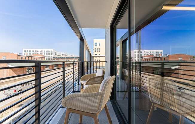 a balcony with chairs and a table at The Box, Richmond, 23224