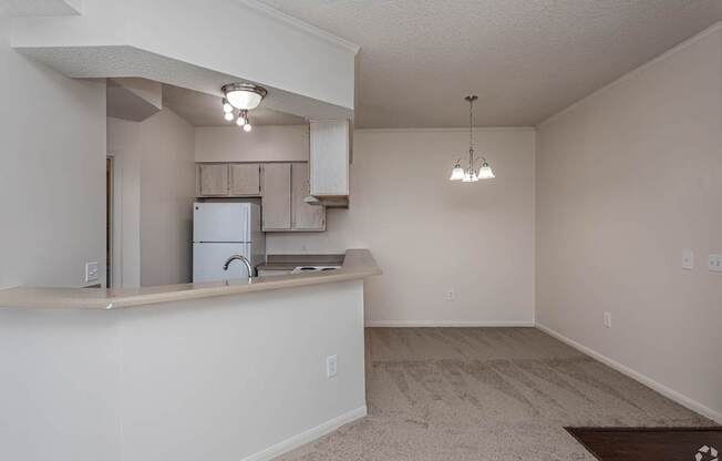A kitchen area with a refrigerator, microwave, and a countertop.