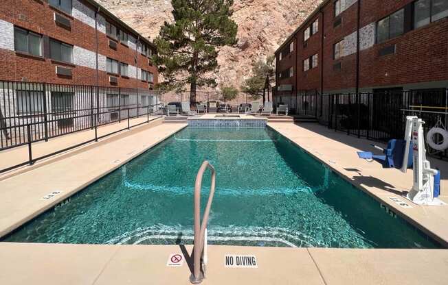 a swimming pool with a mountain in the background
