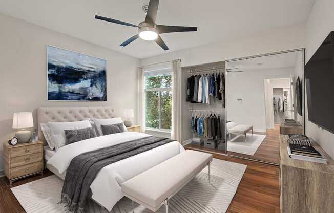 a bedroom with a bed and a ceiling fan