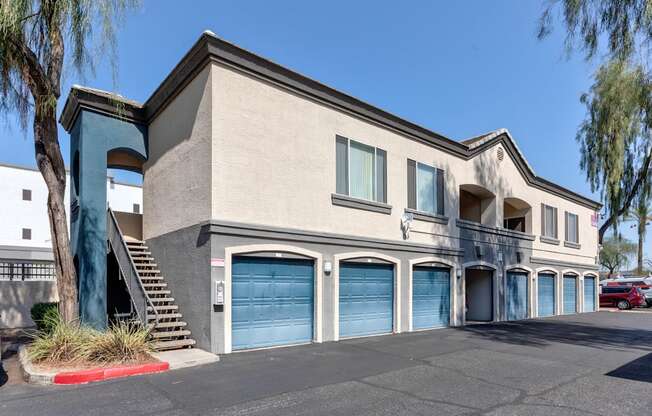 A two-story building with a blue garage door on the ground floor.