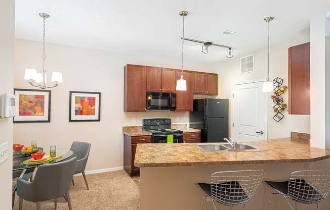 an open kitchen and dining area with a granite counter top