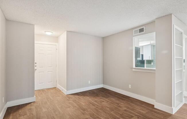 A room with a white door and a window with a white frame.