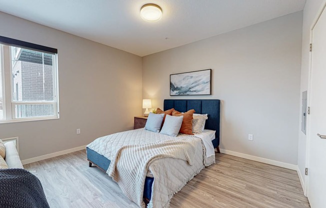 a bedroom with a bed and a window