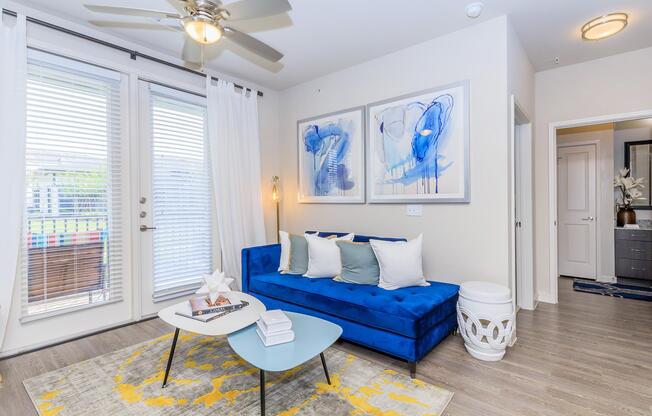 a living room filled with furniture and a large window